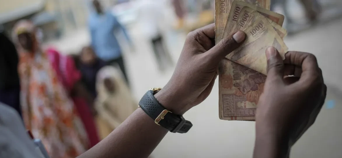 A man counts Somali shilling notes having just exchanged US Dollars