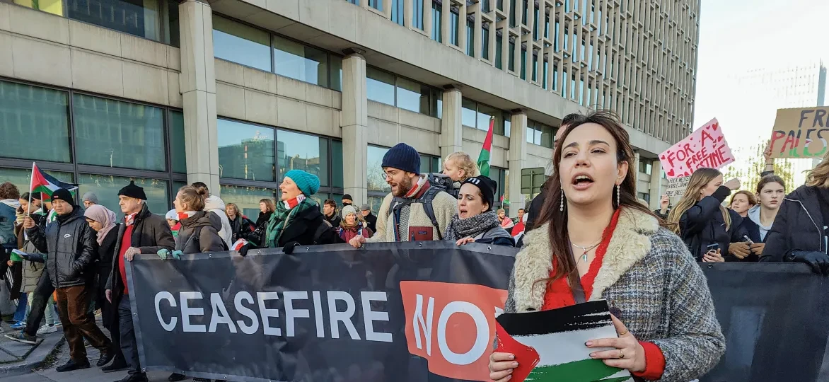 People with 'Cease Fire now' banner during demonstration in Brussels
