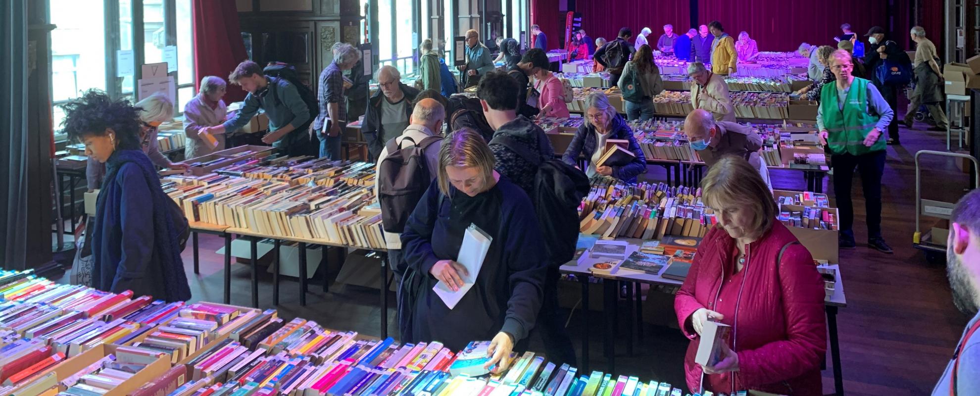 Mensen kiezen hun boek tijdens de boekenverkoop in Gent