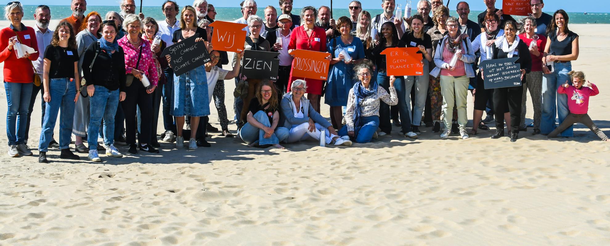 Groepsfoto van alle deelnemers op het strand