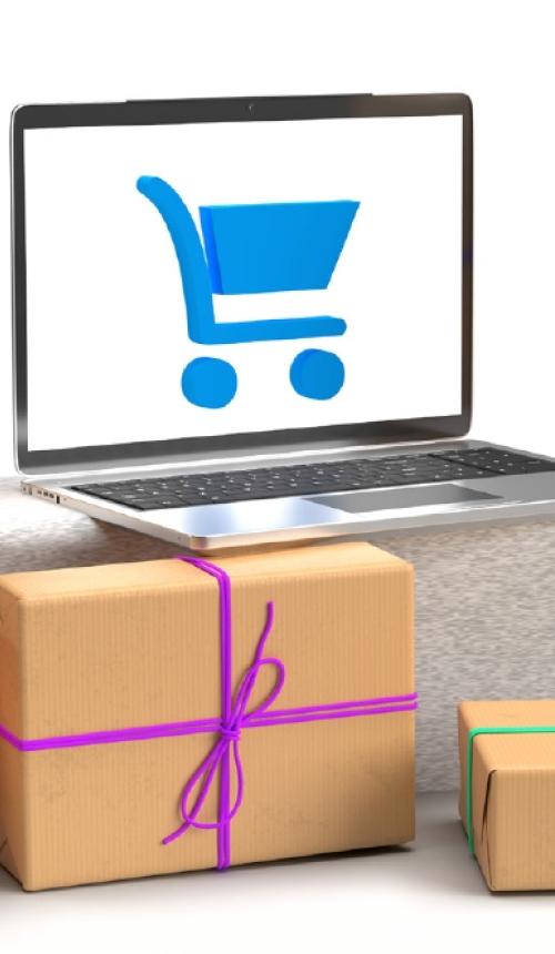 E-commerce - pakjes met laptop en winkelkar