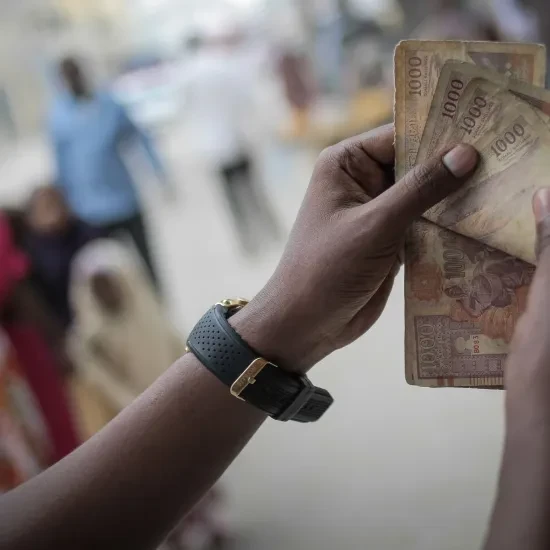 A man counts Somali shilling notes having just exchanged US Dollars