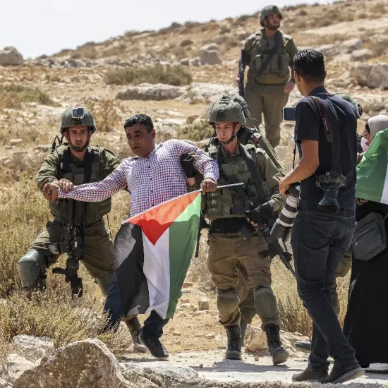 Israëli soldiers arrest a Palestinian demonstrator near Hebron